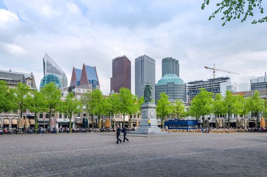 The Hague, Netherlands - May 8, 2015: People at Het Plein in The Hague's city centre, with the statue of William the Silent in the middle. on May 8, 2015.