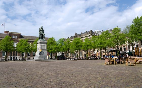 The Hague, Netherlands - May 8, 2015: People at Het Plein in The Hague's city centre, with the statue of William the Silent in the middle. on May 8, 2015.