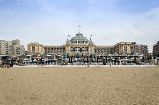 The Hague, Netherlands - May 8, 2015: Tourists at Kurhaus of Scheveningen, The Hague in the Netherlands is a hotel which is called the "Grand Hotel Amrâth Kurhaus The Hague" since October 2014. It is located in the main seaside resort area, near the beach.