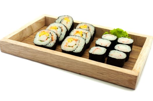 Sushi set in a kitchen board, isolated on white background
