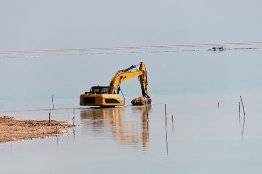 Deepening large bulldozer seabed near the beach on the Dead Sea