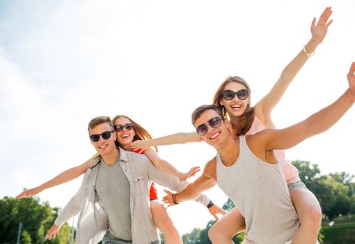 holidays, vacation, love and friendship concept - smiling couple having fun in city