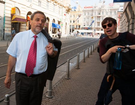 Zagreb mayor, Milan Bandić on city street greeted by a local near the town square.