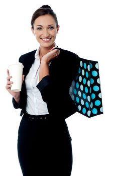 Corporate woman with disposable cup and handbag