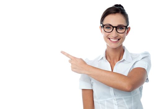 Cheerful woman showing empty copy space