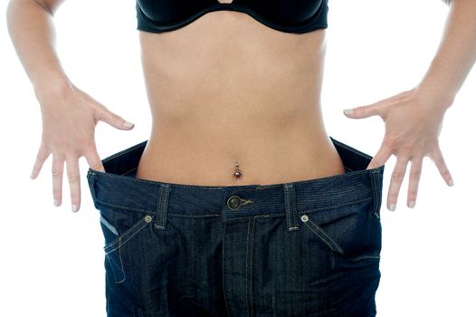 Cropped image of woman with over sized jeans