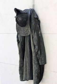 Sculpture of firefighter's uniform hanging on the wall