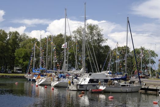 A summer morning at Vadstena harbour in Ostergotland, Sweden.  Vadstena is a popular destination for leisure boats and tourists.