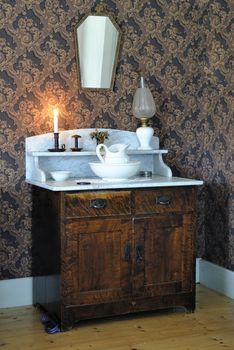 Swedish retro living room with washbasin on a cabinet.