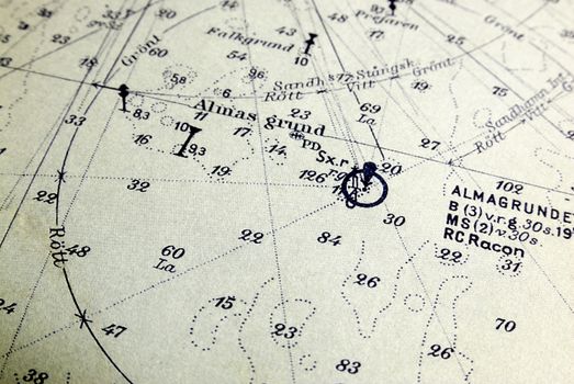 Macro shot of a very old marine chart, detailing Stockholm archipelago with the ground "Almagrundet" in focus.