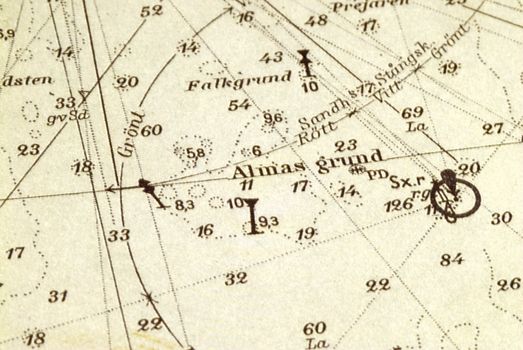 Macro shot of a very old marine chart, detailing Stockholm archipelago with the ground "Almagrundet" in focus.