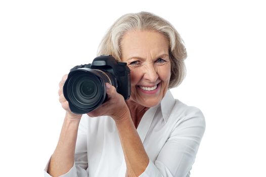 Senior woman taking photos with DSLR camera
