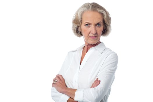 Serious mature woman posing over white