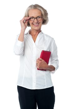 Happy aged woman posing with tablet pc