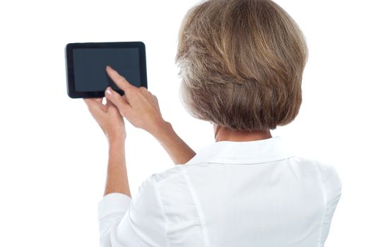 Back view of aged woman showing black screen on tablet
