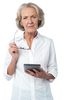 Mature woman with digital tablet and doubtful look