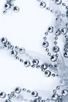 Close up of silver garland. Light background.