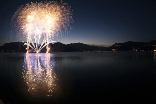 Fireworks on the lakefront of Luino in a beautiful summer evening, Varese - Lombardy, Italy