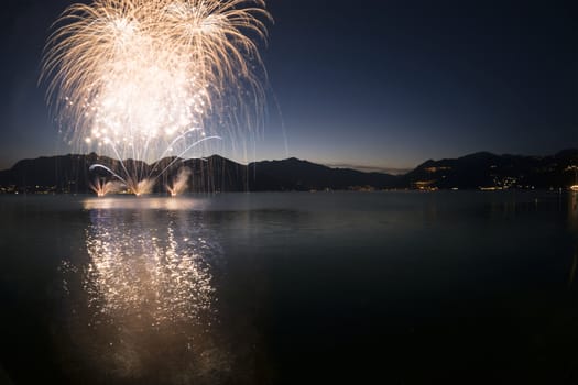 Fireworks on the lakefront of Luino in a beautiful summer evening, Varese - Lombardy, Italy