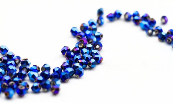 Beautiful glass beads closeup on white background