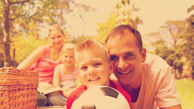 Smiling family relaxing at a picnic together