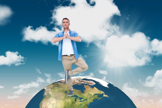 Man with grey hair in tree pose against blue sky