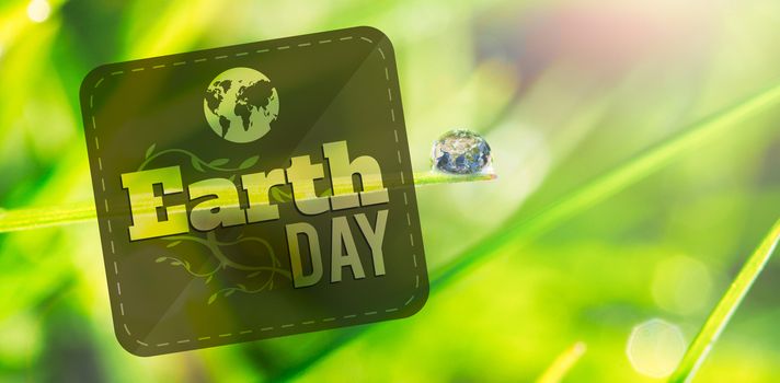 Earth Day Graphic against dew on the grass close up