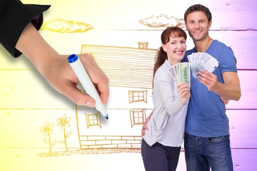 Couple holding fans of cash against painted blue wooden planks