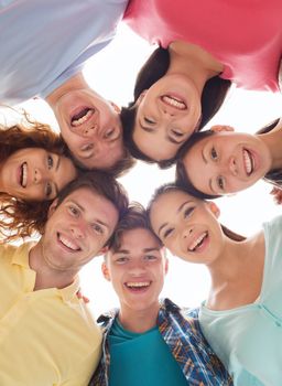 friendship, youth and people - group of smiling teenagers in circle