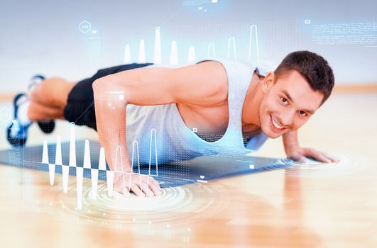 fitness, sport, training, gym and lifestyle concept - smiling man doing push-ups in the gym