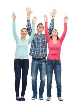 friendship, youth, greeting and people - group of smiling teenagers with raised hands