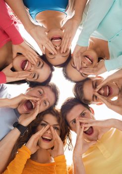 friendship, youth, gesture and people - group of smiling teenagers in circle shouting