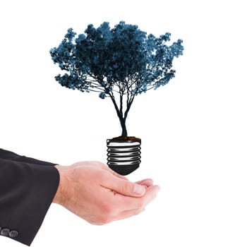 Businessman holding something with his hands against empty light bulb