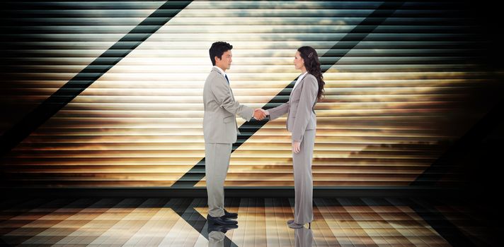 Business people shaking hands against room with large window looking on landscape