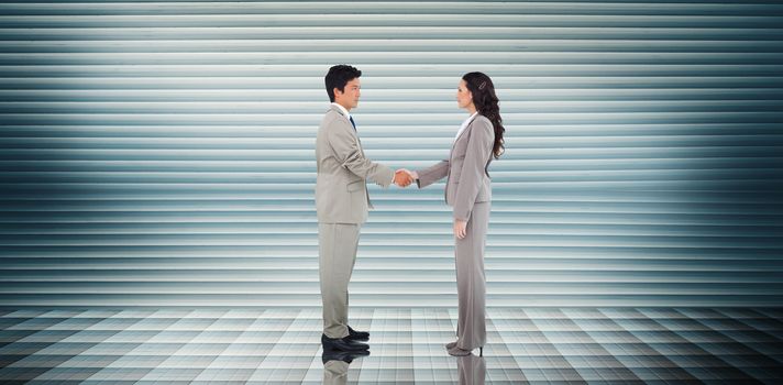 Business people shaking hands against grey shutters