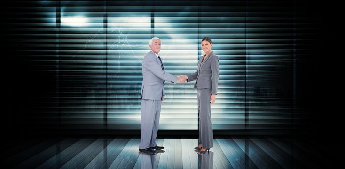 Business team shaking hands against room with large window looking on city