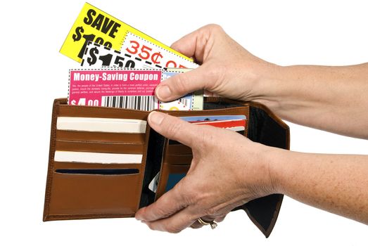 Shopper's hands holding wallet open and pulling out coupons to save money.
