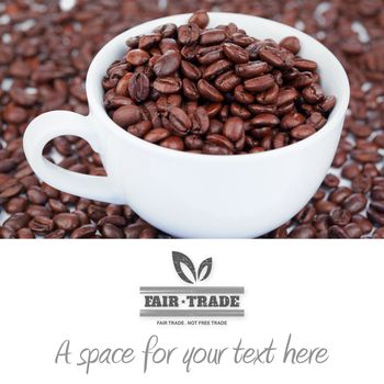 fair trade stamp against small white cup of coffee beans