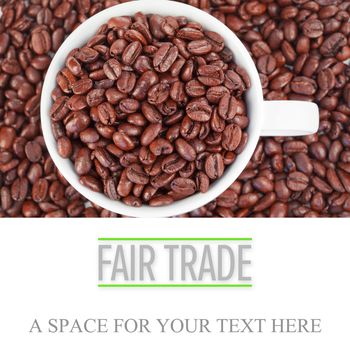 fair trade against small white cup full of coffee beans
