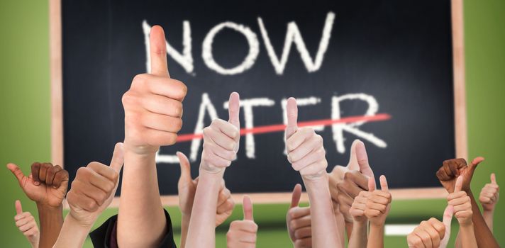 Hands showing thumbs up against now and later written on blackboard