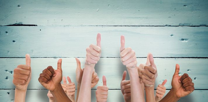 Hands showing thumbs up against painted blue wooden planks