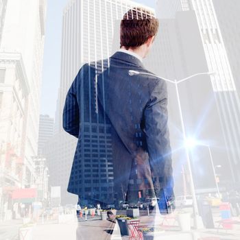 Businessman standing and looking against new york