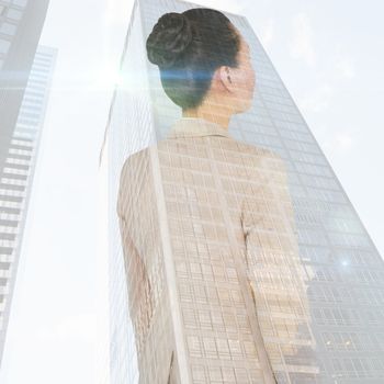 Asian businesswoman against skyscraper