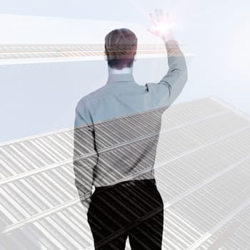 Rear view of businessman in shirt waving  against low angle view of skyscrapers