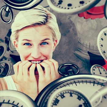 Nervous woman biting her nails looking at camera  against grey background