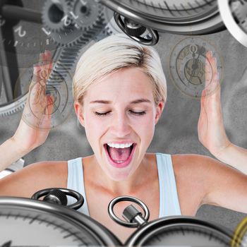 Happy blonde woman screaming with hands up against grey background