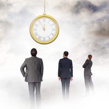 Thinking businessman touching chin against blue sky with white clouds