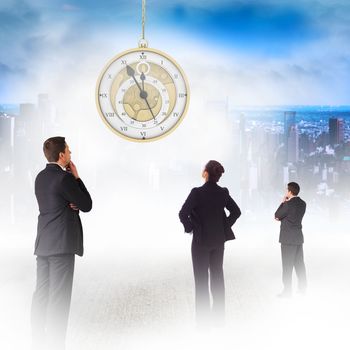 Businessman standing and looking against mirror image of city skyline