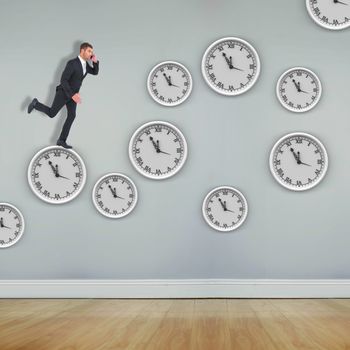 Businessman running on the phone  against room with wooden floor