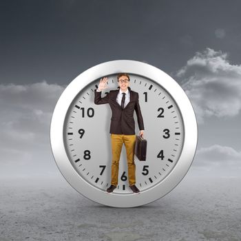 Young geeky businessman holding briefcase against cloudy sky background